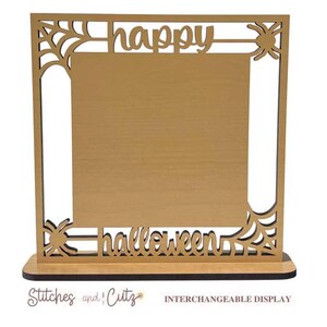 May include: A wooden picture frame with a cutout design of spiderwebs and the words "happy halloween". The frame is brown and has a blank space in the center for a picture.