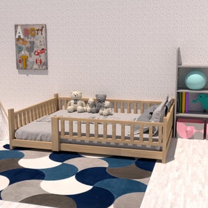 May include: A wooden toddler bed with a white mattress and a blue and gray patterned rug. There are stuffed animals on the bed and a teepee tent in the background.
