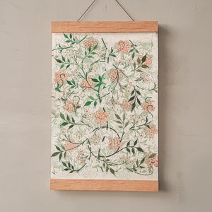 May include: A framed print with a floral design featuring white and orange flowers on a green background. The frame is made of wood and has a simple design.