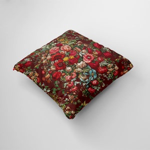 May include: A red throw pillow with a floral pattern featuring a variety of red, pink, and white flowers. The pillow is made of a soft, comfortable fabric and is perfect for adding a touch of elegance to any room.