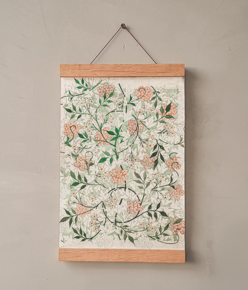 May include: A framed print with a floral design featuring white and orange flowers on a green background. The frame is made of wood and has a simple design.