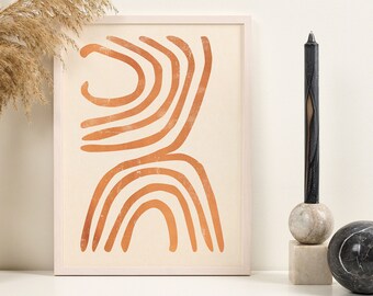 Puede incluir: Una impresión enmarcada con un diseño abstracto de líneas naranjas sobre un fondo crema. La impresión está en un estante blanco con un jarrón de hierba de la pampa seca y una vela negra en un soporte de mármol.