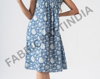 May include: A blue and white floral print midi dress with a gathered neckline and short sleeves.
