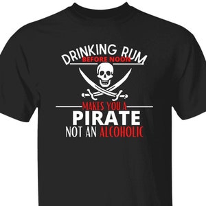 May include: Black t-shirt with white text that reads "Drinking Rum Before Noon Makes You A Pirate Not An Alcoholic". A white skull and crossbones graphic is above the text.