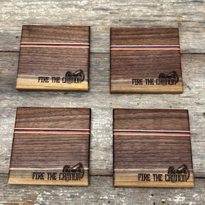 May include: Set of four wooden coasters with a red, white, and blue stripe design. Each coaster features a laser-engraved cannon and the text "Fire the Cannon".