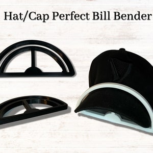 May include: Black hat bill bender tool with the text "Hat/Cap Perfect Bill Bender". The tool is black and white and is designed to shape the bill of a hat. A black hat is shown with the tool in use.