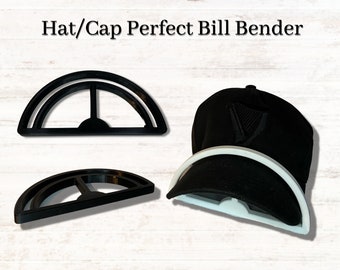 May include: Black hat bill bender tool with the text "Hat/Cap Perfect Bill Bender". The tool is black and white and is designed to shape the bill of a hat. A black hat is shown with the tool in use.