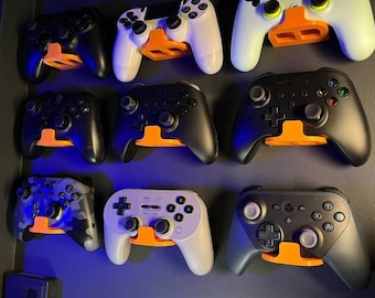 Soporte de pared universal para mandos de videojuegos. ¡Convierte cualquiera de tus mandos antiguos en un elegante elemento decorativo para la pared! Varios colores disponibles. Envíos a todo el mundo.