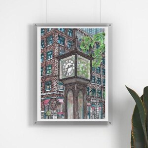 May include: Watercolor painting of a street clock tower with a building in the background. The clock tower is dark brown with a square clock face. The building is brick with green-framed windows. The artwork is framed and hanging on a white wall.