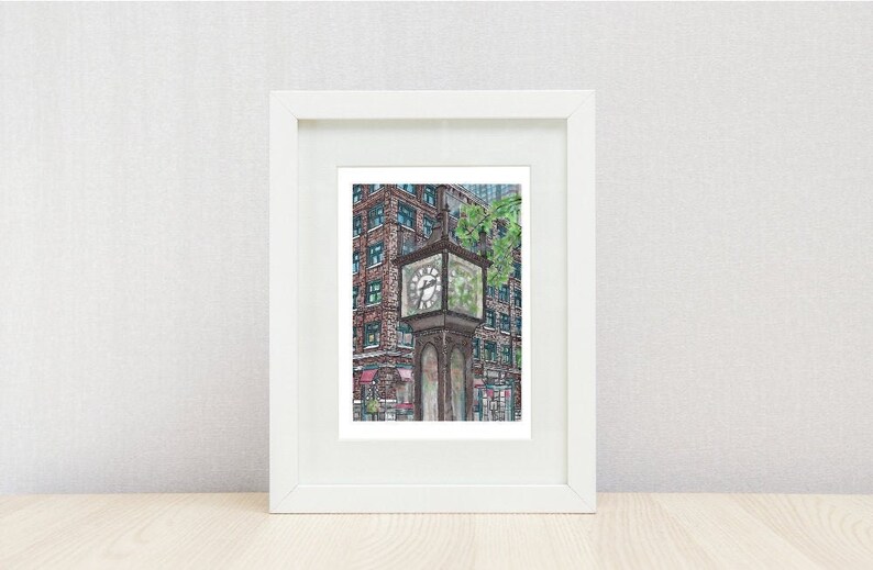 May include: A framed watercolor print of a city scene featuring a vintage clock tower. The clock has a square face and is set against a backdrop of a brick building with green-framed windows. Green foliage is visible.
