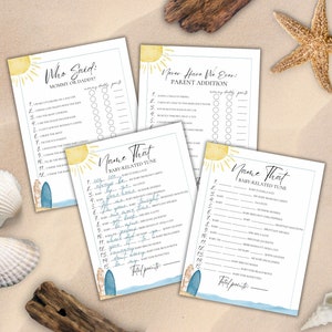 May include: Four baby shower game cards with a beach theme. Each card features a sun illustration and text like "Who Said: Mommy or Daddy?" and "Name That Baby-Related Tune." The cards are on a sandy surface with seashells and driftwood.