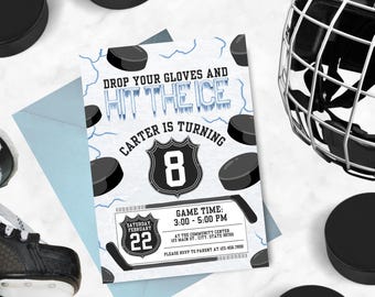 May include: A hockey-themed birthday party invitation with a blue and white background. The invitation features a hockey puck, a hockey stick, and a hockey helmet. The text on the invitation reads "Drop your gloves and hit the ice. Carter is turning 8. Saturday, February 22. Game time: 3:00-5:00 PM. At the Community Center, 123 Main St, City, State 98765. Please RSVP to parent at 123.456.7800."