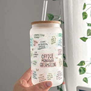 May include: White frosted glass tumbler with a bamboo lid and a straw. The tumbler has colorful text with affirmations for office managers, including "I am an amazing office manager" and "Office Manager Affirmations".