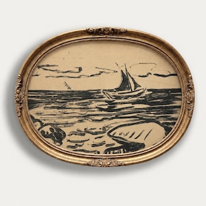 May include: An oval-shaped artwork in a decorative gold frame featuring a black ink drawing on a beige background. The illustration depicts a sailboat on the water with stylized waves in the foreground and simple cloud shapes in the sky above.