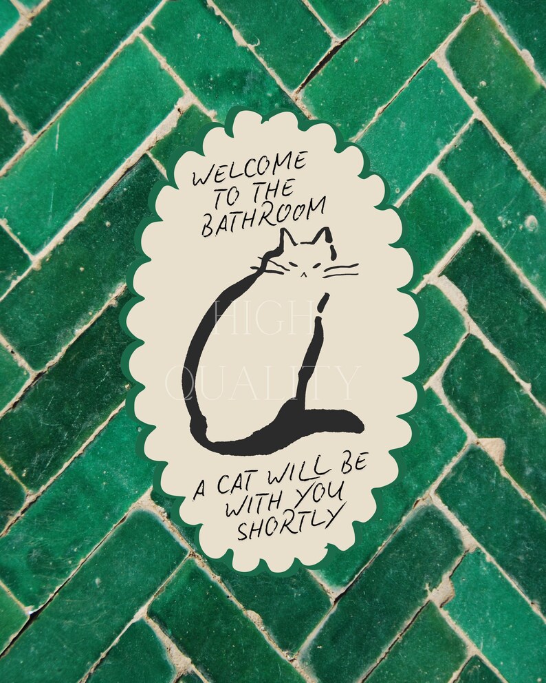 May include: An oval-shaped sticker with a scalloped edge featuring a cream background and a black line drawing of a cat. The text reads: WELCOME TO THE BATHROOM, A CAT WILL BE WITH YOU SHORTLY. The sticker has a dark green border.