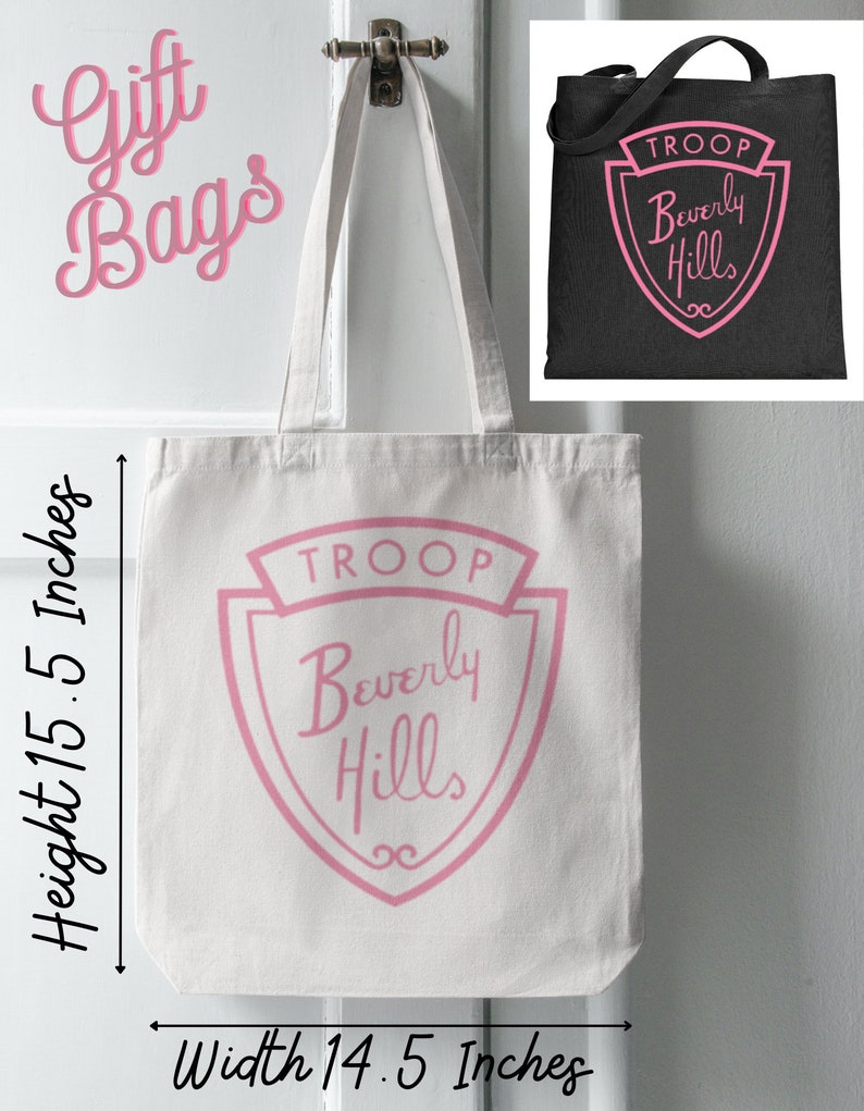Puede incluir: Bolsa de lona blanca con letras rosas que dicen "TROOP Beverly Hills" en forma de escudo. La bolsa mide 14,5 pulgadas de ancho y 15,5 pulgadas de alto.