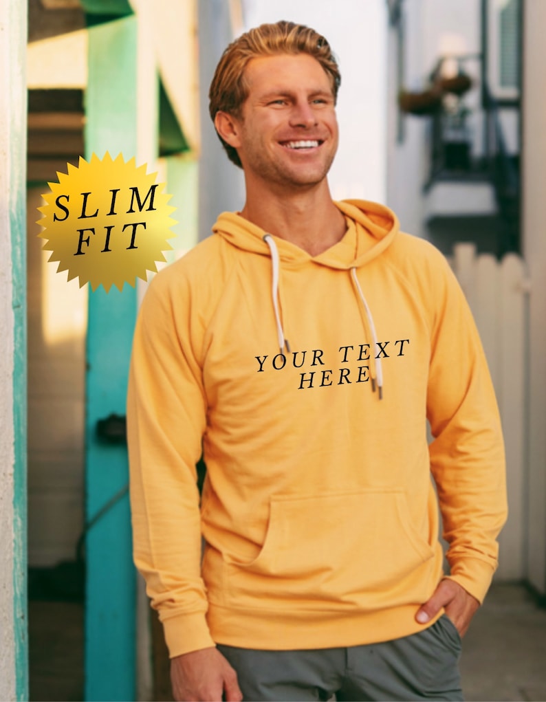 May include: A yellow slim fit hoodie with a white drawstring and the text "YOUR TEXT HERE" printed on the front.