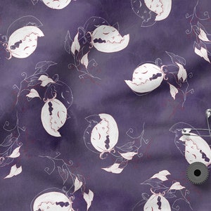 May include: Purple fabric with a white floral pattern. The fabric has a subtle watercolor effect. There are safety pins and a black spool of thread on the fabric.