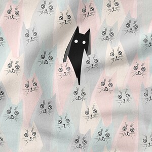 May include: A black cat stands out against a background of many pastel-colored cats with black eyes and whiskers. The cats are arranged in a repeating pattern.