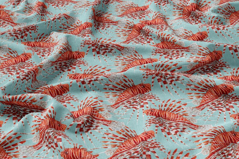 May include: A blue fabric with a repeating pattern of red and white lionfish. The lionfish are depicted in a realistic style with intricate details.