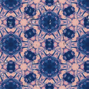 May include: A pink and blue patterned fabric with a repeating geometric design. Water droplets are scattered across the surface.