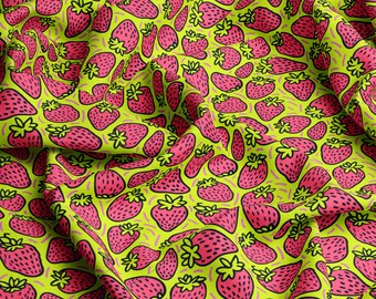 May include: A green fabric with a repeating pattern of pink strawberries. The strawberries are outlined in black and have a white seed detail.