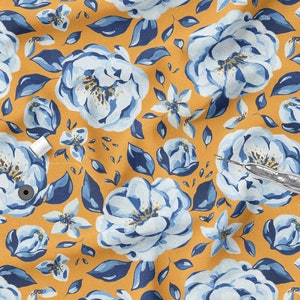 May include: A yellow fabric with a blue and white floral pattern. The fabric features large white flowers with blue centers and blue leaves. The fabric is perfect for crafting projects, such as quilting, sewing, and scrapbooking.