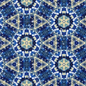 May include: A blue and white patterned design with a kaleidoscope effect. The pattern is made up of geometric shapes and swirls. The background is a light blue color.