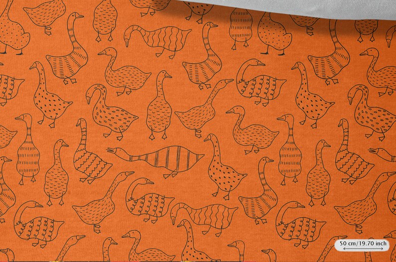 May include: Orange fabric with a repeating pattern of black geese. The geese are stylized and have different patterns on their bodies. The fabric is 50 cm / 19.70 inches wide.