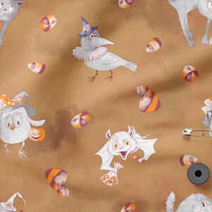 May include: A seamless pattern featuring a variety of Halloween characters, including a cat, an owl, a bat, and a crow. The characters are all white with black accents and are set against a brown background with orange and black candy corn scattered throughout.