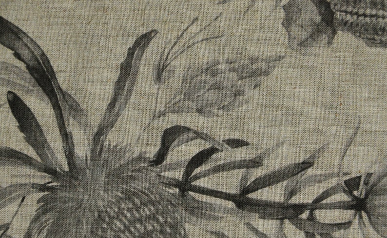 May include: A black and white floral print on a textured linen fabric. The print features stylized flowers and leaves.