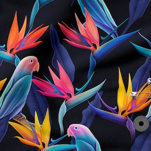 May include: A dark blue fabric with a repeating pattern of colourful bird of paradise flowers and blue parrots. The fabric also features safety pins and a metal gear.