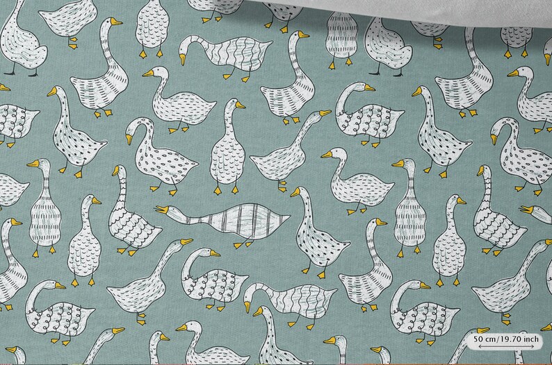 May include: A teal blue fabric with a repeating pattern of white geese. The geese have different patterns on their bodies, including dots, stripes, and wavy lines. The geese have yellow beaks and feet.