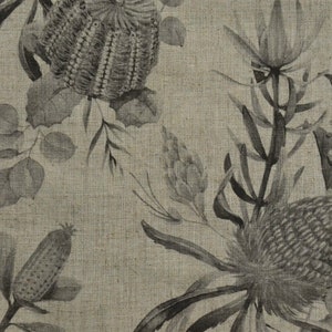 May include: A beige linen fabric with a black and white floral print featuring stylized flowers and leaves. The print is reminiscent of Australian flora.