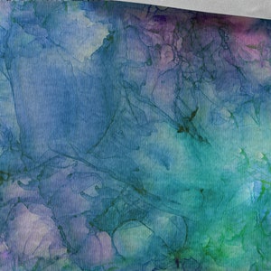 May include: Abstract watercolour painting with shades of blue, green, and purple. The colours blend together to create a swirling, ethereal effect. The painting is 50 cm / 19.70 inches wide.