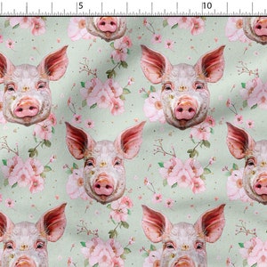 May include: A seamless pattern featuring pink pig faces with pink flowers on a light green background.