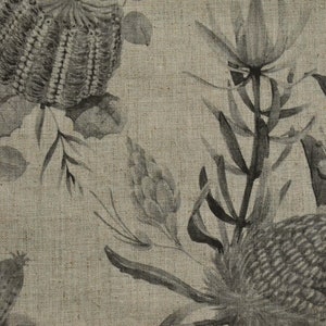 May include: A beige linen fabric with a black and white floral print. The print features stylized flowers and leaves.