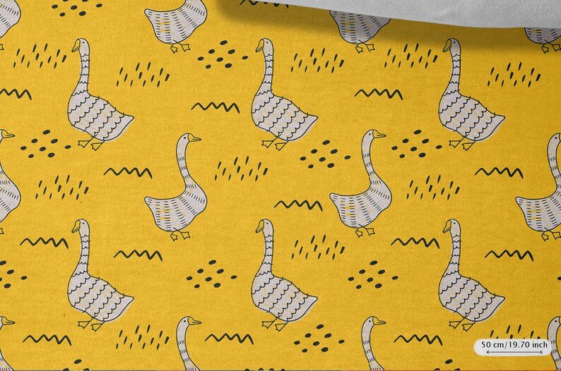 May include: Yellow fabric with a repeating pattern of gray geese and black abstract shapes. The fabric is 50 cm / 19.70 inches wide.