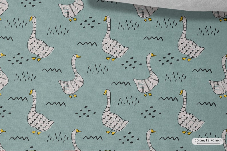 May include: A teal blue fabric with a repeating pattern of white geese with yellow beaks and black eyes. The geese are surrounded by black abstract shapes and wavy lines.