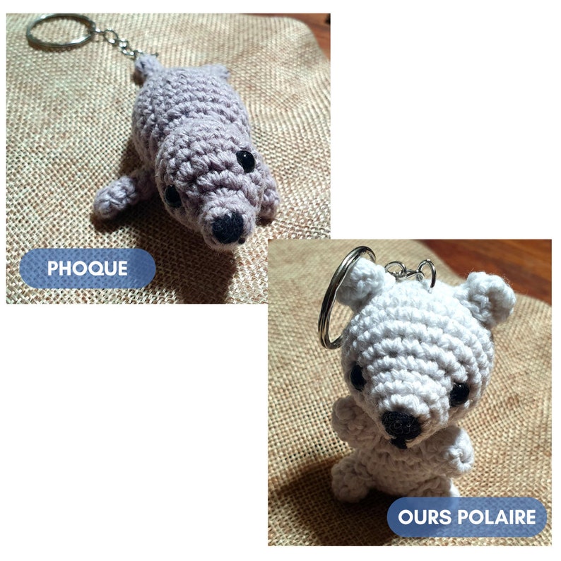 K&ouml;nnte beinhalten: Zwei geh&auml;kelte Tier-Schl&uuml;sselanh&auml;nger, ein grauer Seehund mit dem Wort "PHOQUE" und ein wei&szlig;er Eisb&auml;r mit dem Wort "OURS POLAIRE".