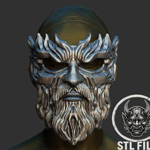 May include: A detailed, silver-colored mask with a stylized bearded face and crown-like details. The mask has a stern expression and is set against a dark background. A circular graphic with a horned demon face and the text "STL FILE" is in the lower right.