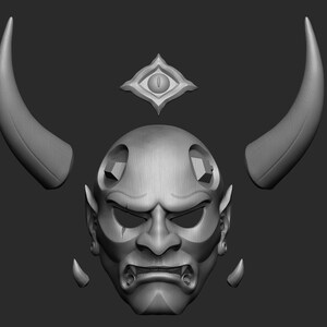 May include: A grey 3D printed Oni mask with horns and a third eye. The mask is separated into five pieces: the face, two horns, and two ear pieces.