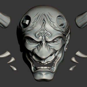 May include: A detailed, gray, 3D printed model of a Japanese Oni mask with horns. The mask has a fierce expression with a wide open mouth and sharp teeth. The horns are separate pieces.