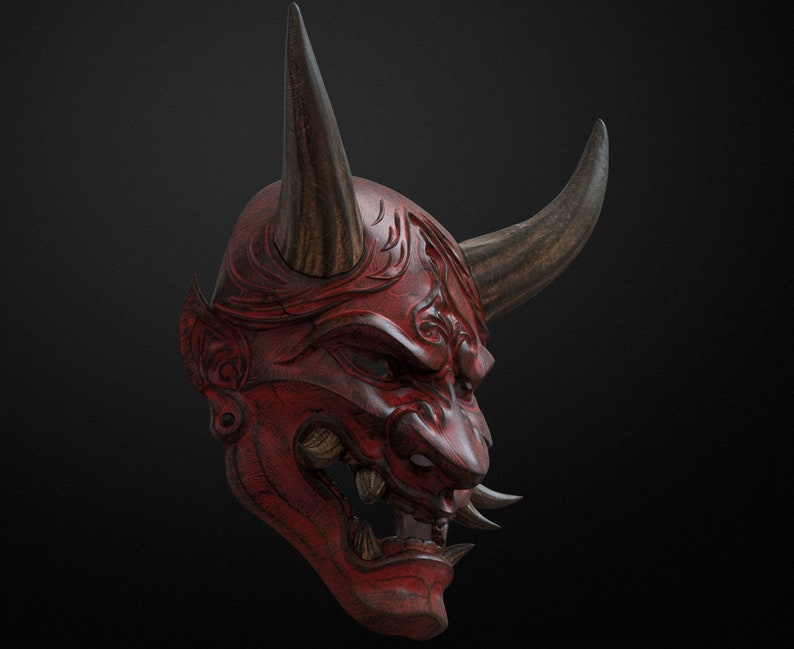 May include: A red wooden Japanese Oni mask with black horns and intricate carvings. The mask has a fierce expression with sharp teeth and a wide open mouth.