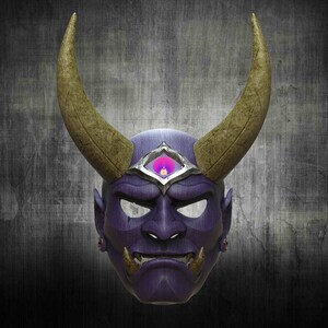 May include: A purple and gold Oni mask with a third eye in the centre of the forehead. The mask has horns and a fierce expression.