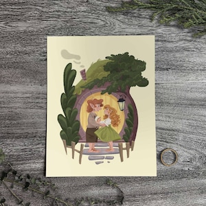 May include: Illustration of a couple dancing in front of a hobbit hole. The artwork features a round yellow door, green roof, and a black lantern. The couple is depicted with red hair and wearing brown and green clothing. The background is a light beige.