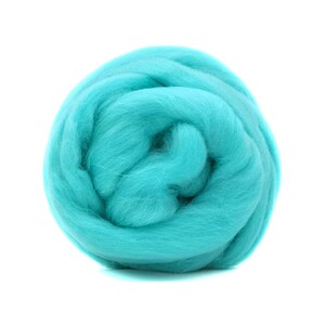 Puede incluir: Una bola de lana roving azul turquesa, un tipo de fibra utilizada para el fieltro y el hilado.