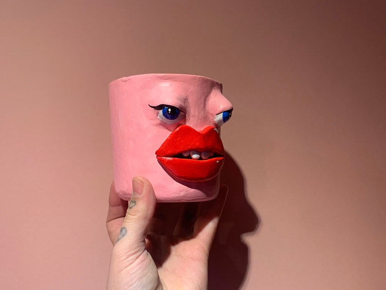 Quirky strange head face pot pink eyes and lips weird art image 2