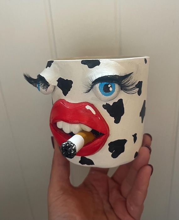 Funny, weird face planter with eyes, lashes, cigarette and lips