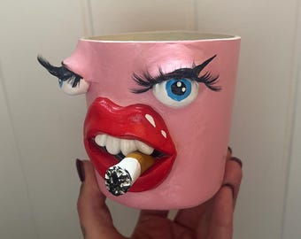 Pink funny planter with eyes, cigarette and mouth